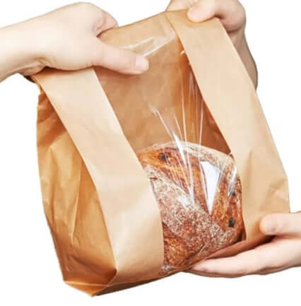 Mână care ține o punga cu fereastra paine taraneasca 18x7x51, cu fereastră transparentă pentru o prezentare elegantă.